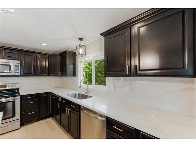 a kitchen with a sink and cabinets