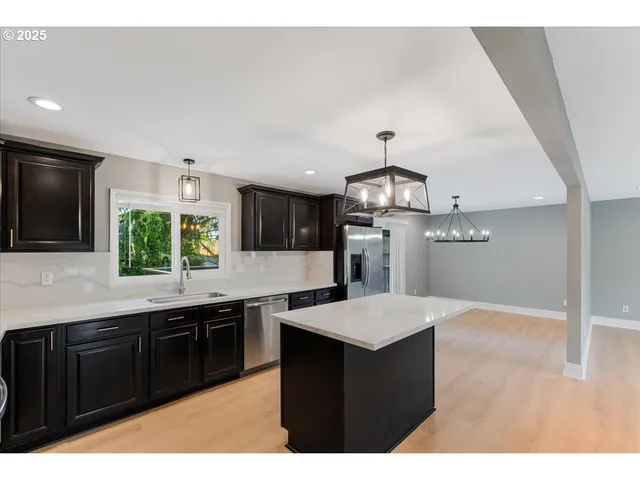 a kitchen with a sink a counter top space and appliances