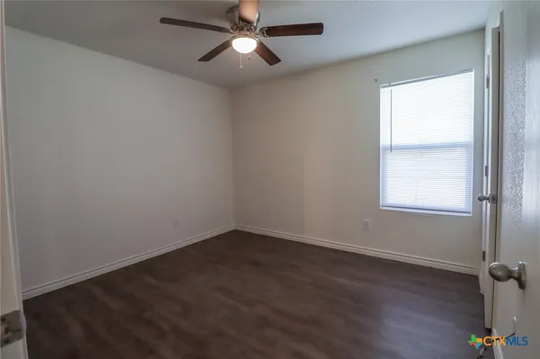 a view of a small space with wooden floor and a window