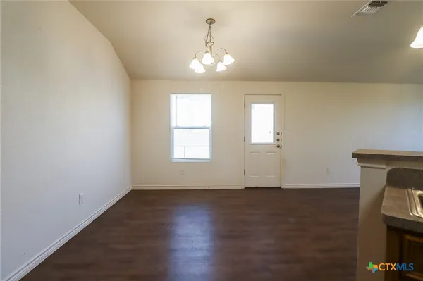 a view of a kitchen with a sink wooden floor and a large window