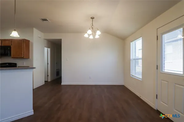 a kitchen with stainless steel appliances granite countertop a refrigerator a stove a sink and a microwave