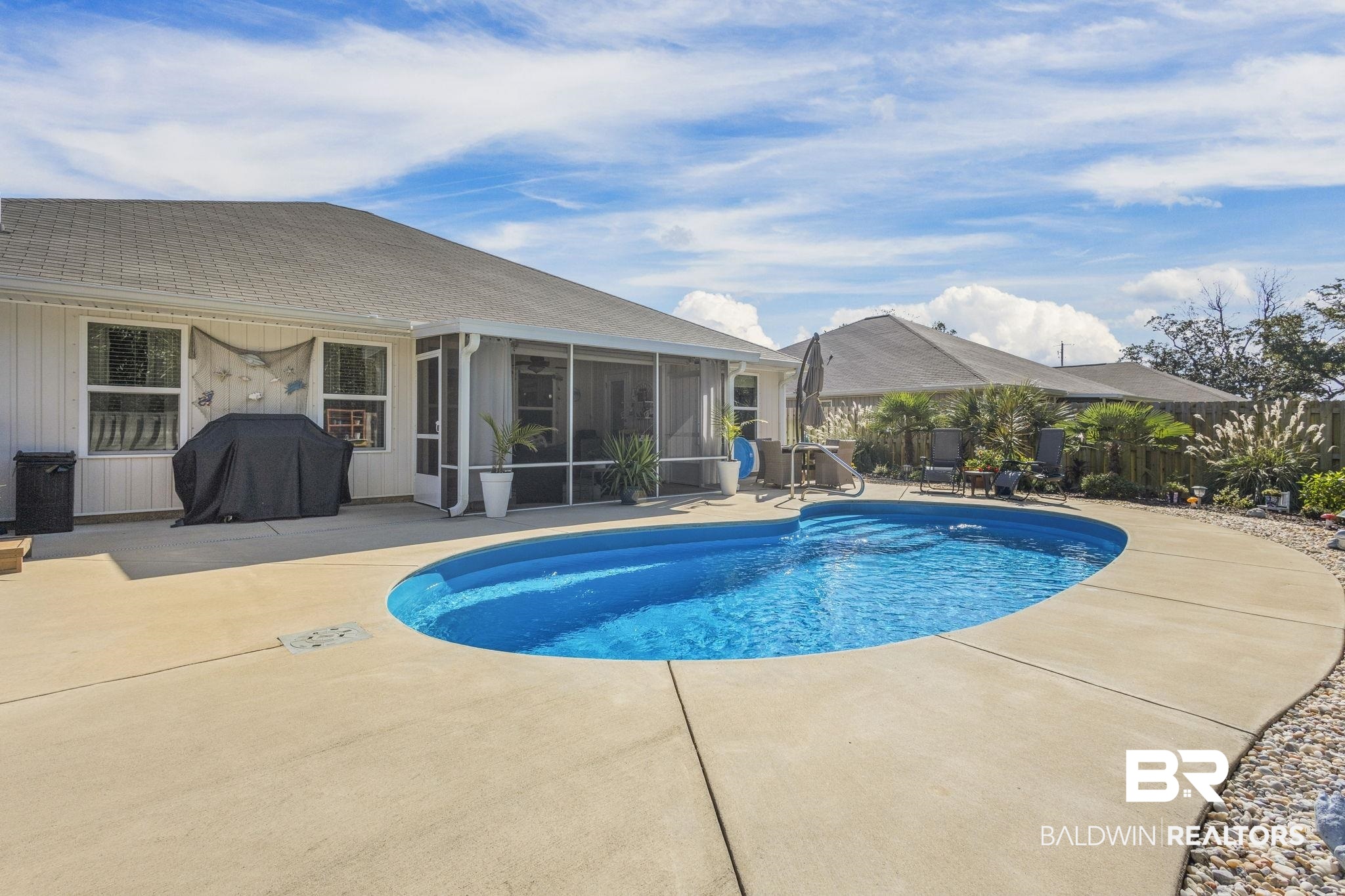345 Hartenstein Road Foley, AL 36535 - Photo 41 of 47 View of swimming pool with a patio, a grill, and a sunroom