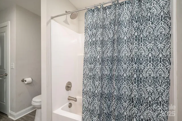 a bathroom with a shower curtain