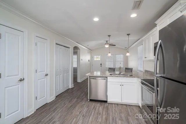 a kitchen with a sink stainless steel appliances and cabinets