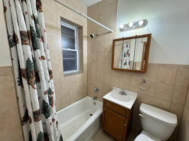 a bathroom with a toilet sink and tub
