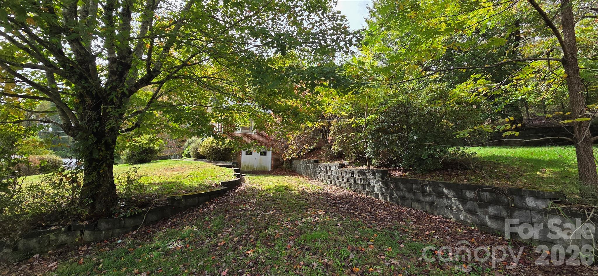 214 Old Dale Road Spruce Pine, NC 28777 - Photo 13 of 39 a view of a yard with large trees