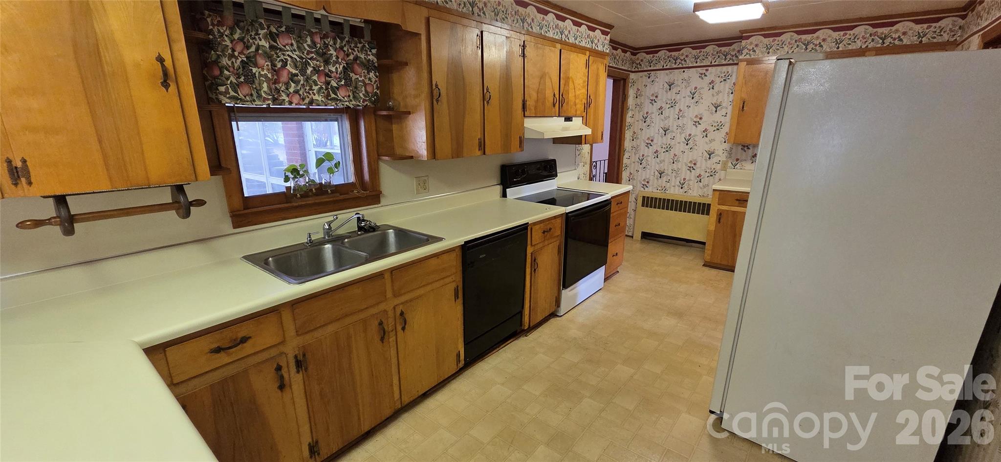 214 Old Dale Road Spruce Pine, NC 28777 - Photo 14 of 39 a kitchen with a sink and a refrigerator