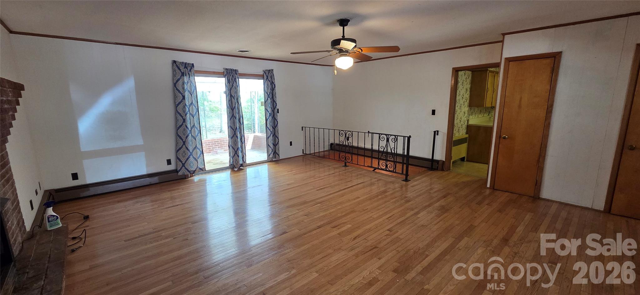 214 Old Dale Road Spruce Pine, NC 28777 - Photo 17 of 39 an empty room with wooden floor and windows