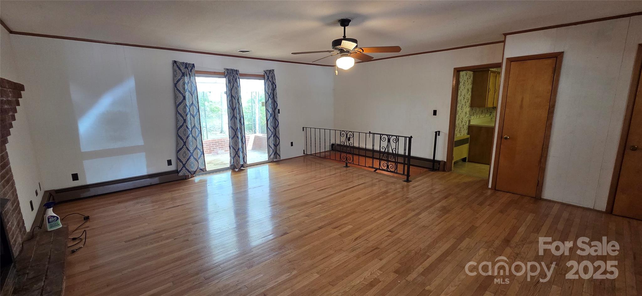214 Old Dale Road Spruce Pine, NC 28777 - Photo 17 of 42 an empty room with wooden floor and windows