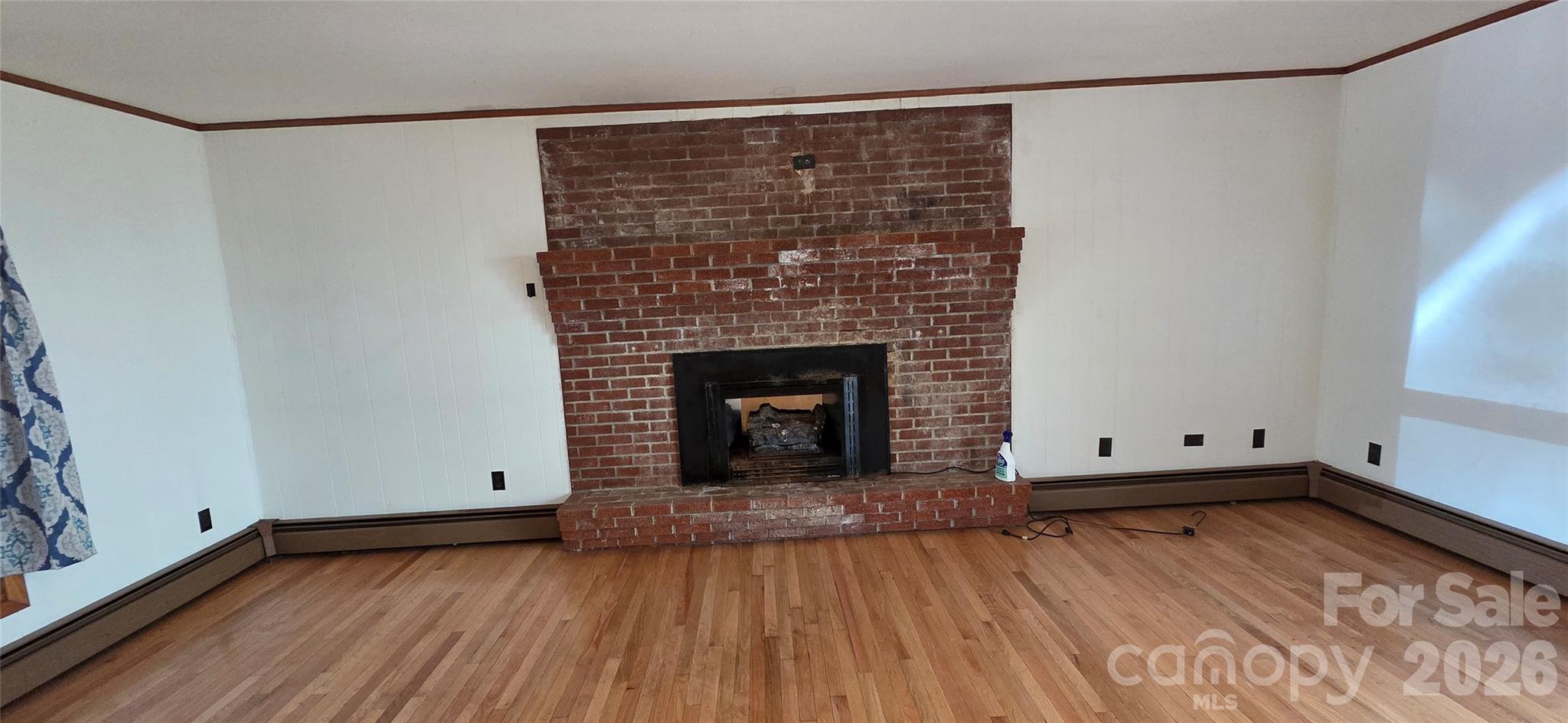 214 Old Dale Road Spruce Pine, NC 28777 - Photo 18 of 39 a view of empty room with wooden floor and fireplace