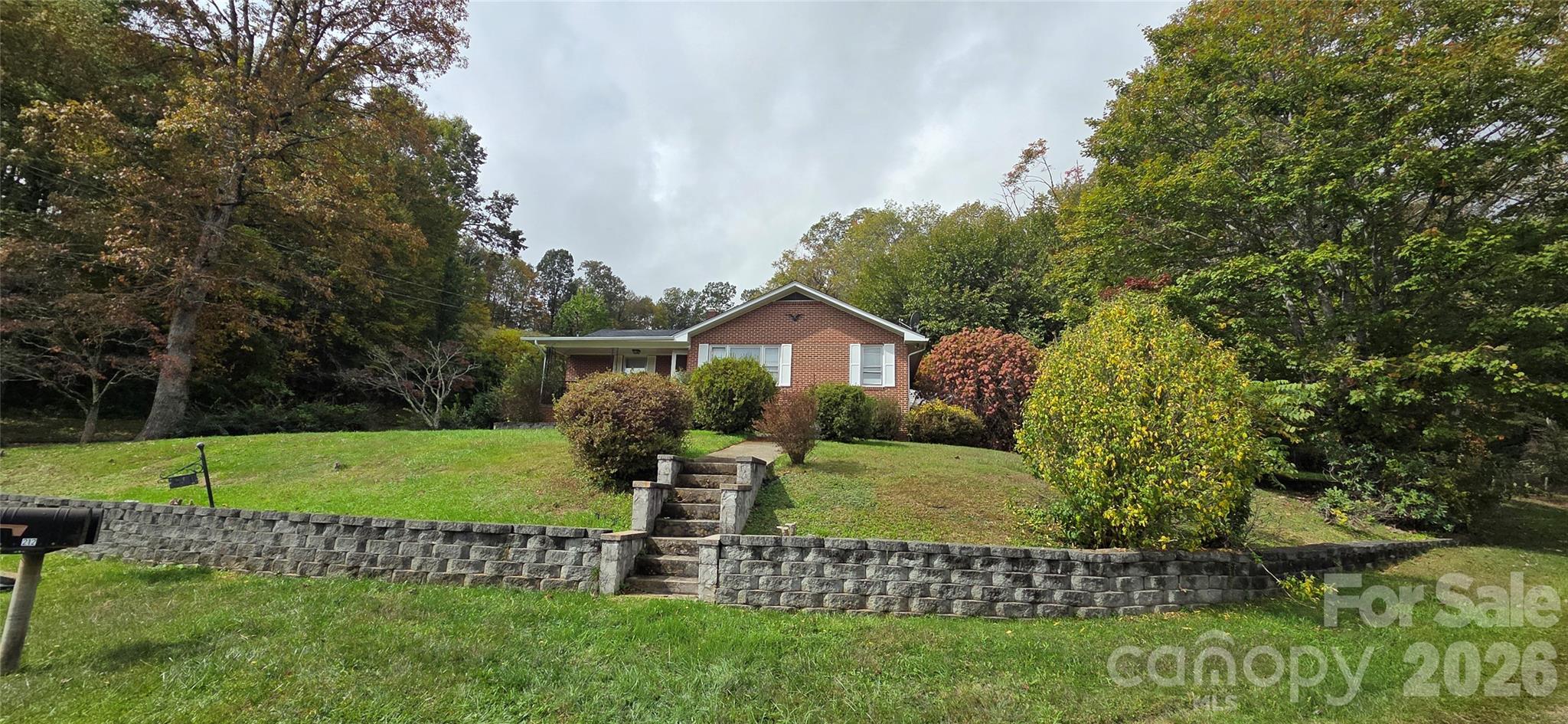 214 Old Dale Road Spruce Pine, NC 28777 - Photo 2 of 39 a view of a house with a big yard and a large tree