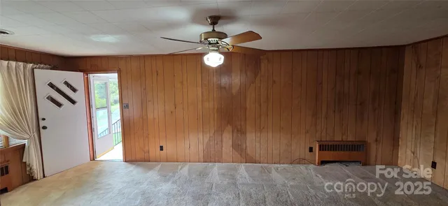 a view of livingroom with furniture and chandelier fan