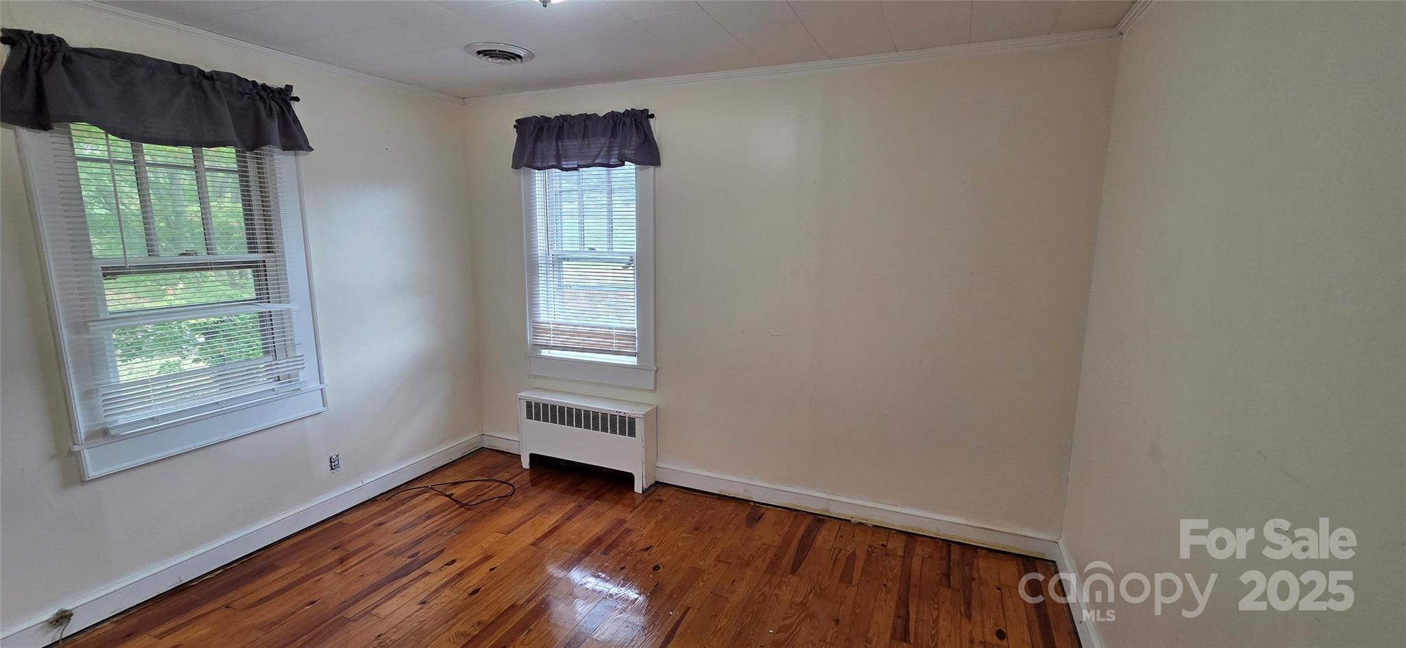 214 Old Dale Road Spruce Pine, NC 28777 - Photo 25 of 42 a view of an empty room with wooden floor and a window