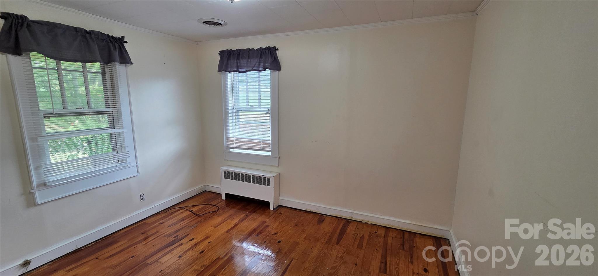 214 Old Dale Road Spruce Pine, NC 28777 - Photo 25 of 39 a view of an empty room with wooden floor and a window