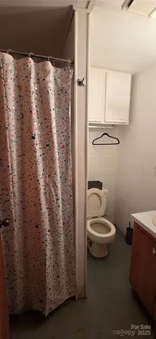 a bathroom with a toilet a sink and a shower