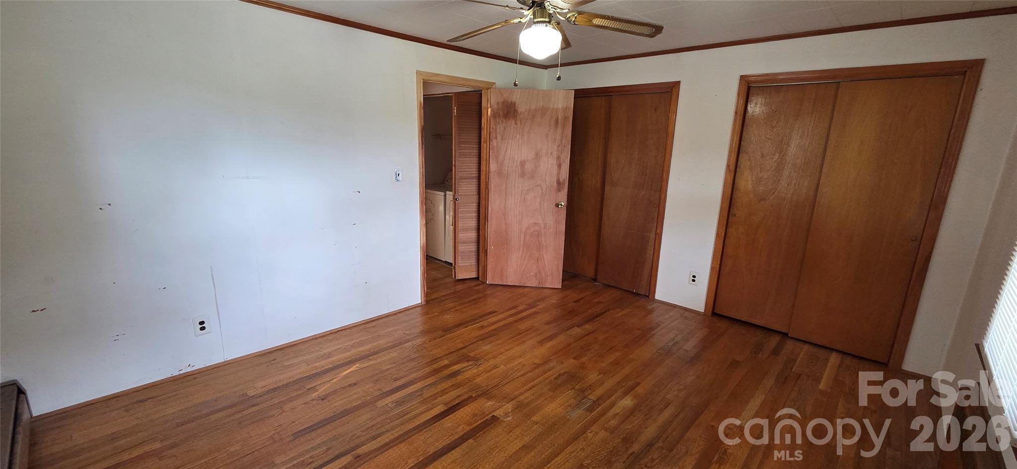 214 Old Dale Road Spruce Pine, NC 28777 - Photo 33 of 39 an empty room with wooden floor and fan