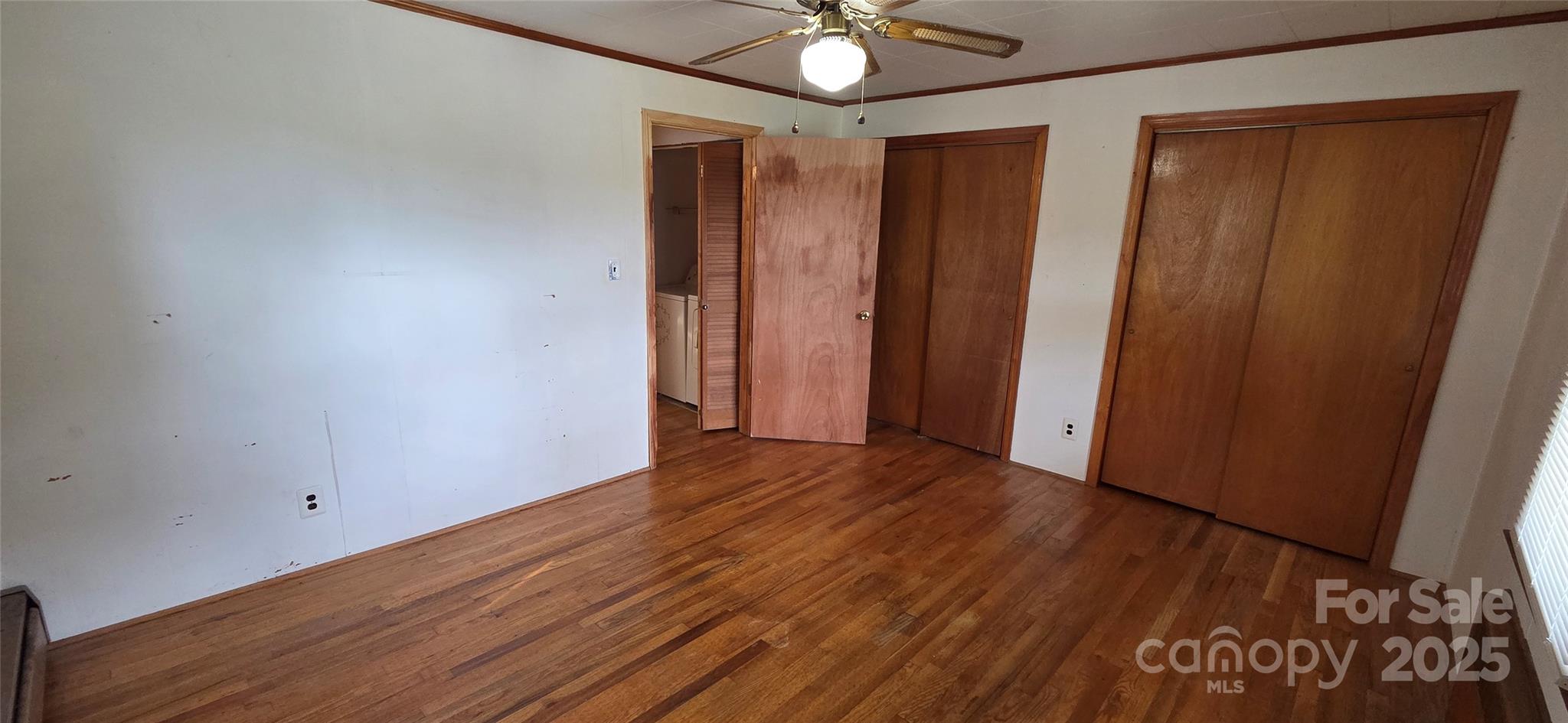 214 Old Dale Road Spruce Pine, NC 28777 - Photo 33 of 42 an empty room with wooden floor and fan