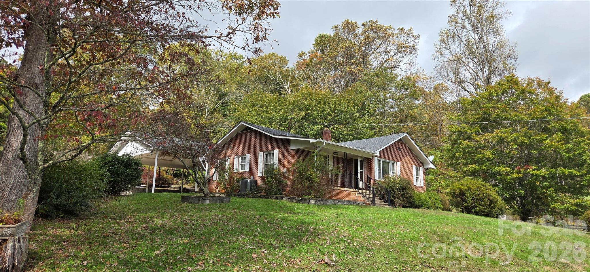 214 Old Dale Road Spruce Pine, NC 28777 - Photo 6 of 39 a front view of a house with a yard and trees