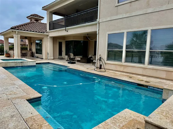 a view of a house with swimming pool and porch