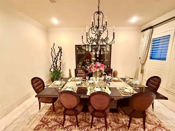 a view of a dining room with furniture and chandelier
