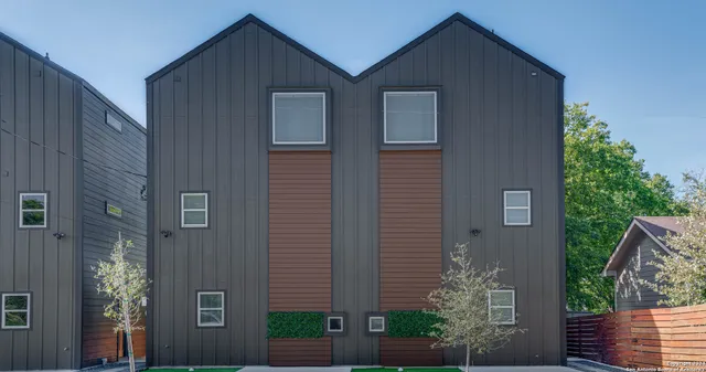 a front view of a house with plants
