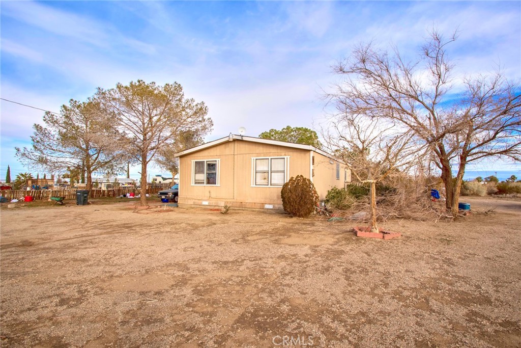 13839 Rapture Road Phelan, CA 92371 - Photo 1 of 1 a view of a yard with a house and a large tree