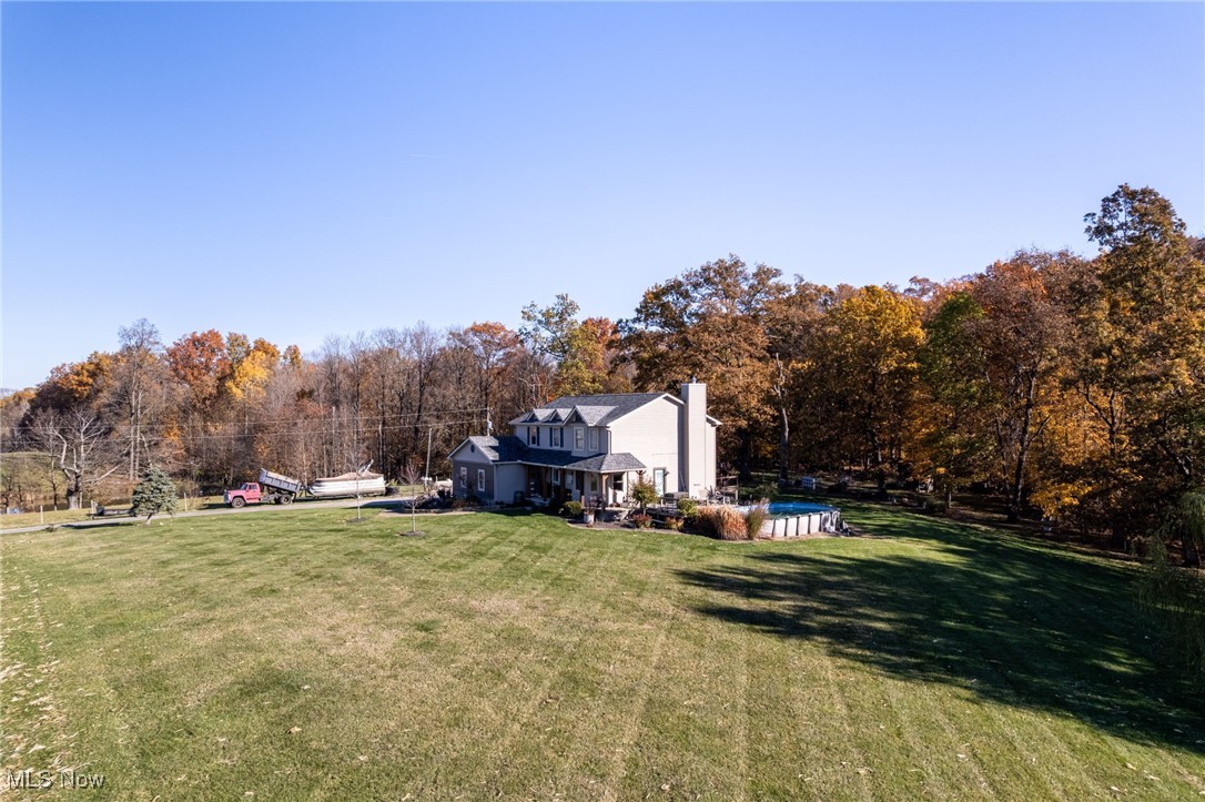 11827 Stratton Road West Salem, OH 44287 - Photo 5 of 47 View of grassy yard featuring an outdoor pool