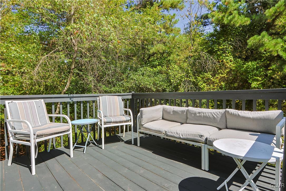 1648 Clover Road North Long Pond, PA 18334 - Photo 6 of 50 a view of a patio with couches and a dining table and chairs with wooden floor