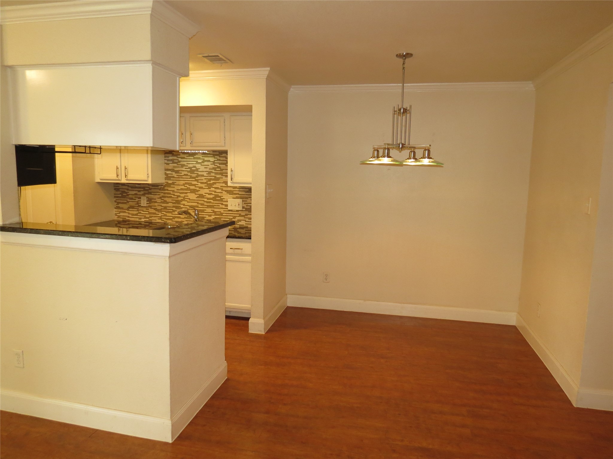 4159 Steck Avenue, Unit 269 Austin, TX 78759 - Photo 21 of 21 An open floorplan seamlessly connects the kitchen and dining areas, boasting rich hardwood flooring throughout.