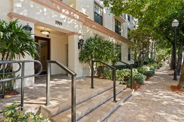 a front view of multiple houses with yard