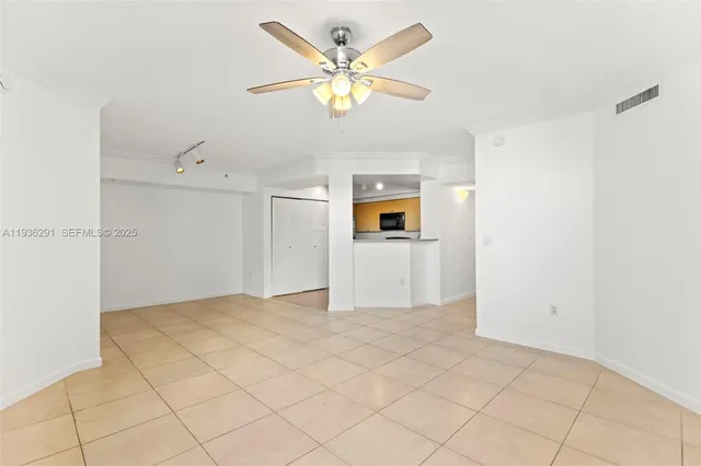 a view of a kitchen with a sink dishwasher a refrigerator with white cabinets and chandelier