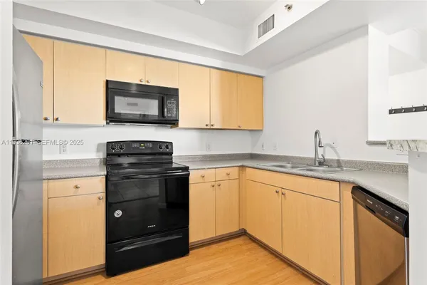 a kitchen with a sink stove and microwave