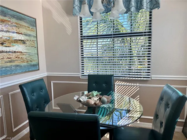 a view of a dining room with furniture and chandelier
