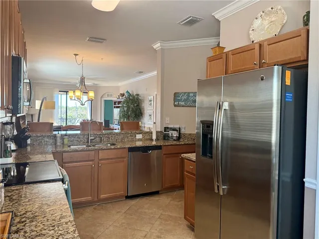 a kitchen with refrigerator and cabinets