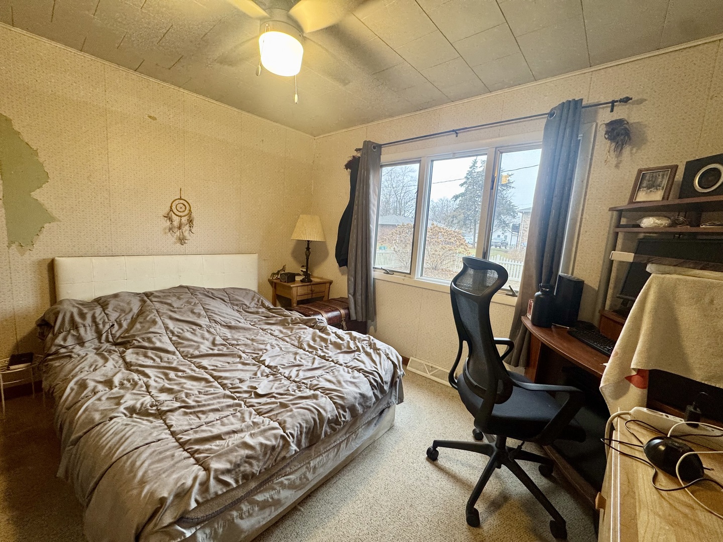 206 East Warren Street Le Roy, IL 61752 - Photo 14 of 18 a bedroom with a bed a desk and chair with wooden floor