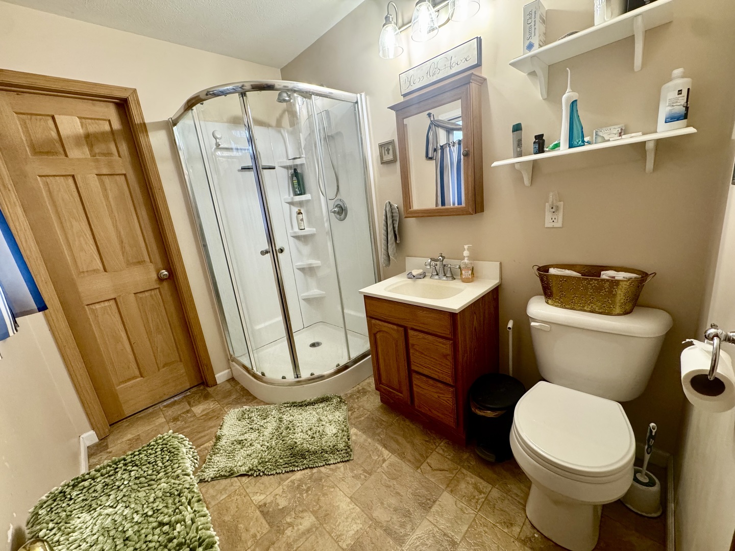 206 East Warren Street Le Roy, IL 61752 - Photo 4 of 18 a bathroom with a sink a toilet and a mirror