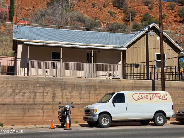 a kitchen with stainless steel appliances granite countertop white cabinets a sink and a stove