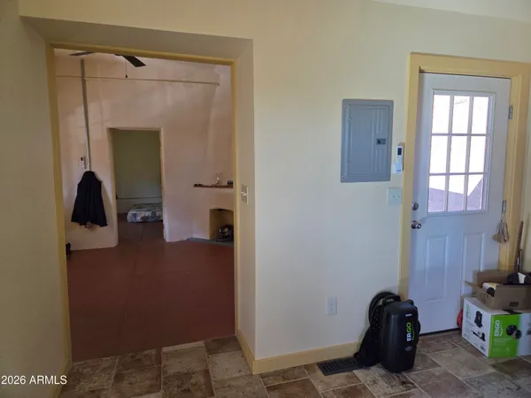 a bedroom with a bed and a painting on the wall