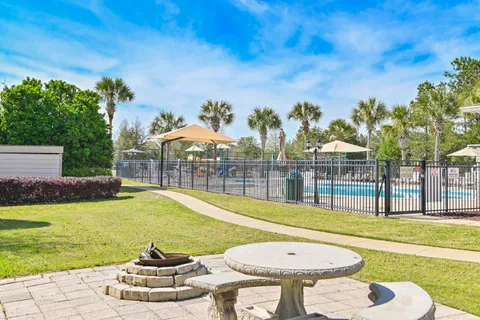 a patio with a table and chairs under an umbrella