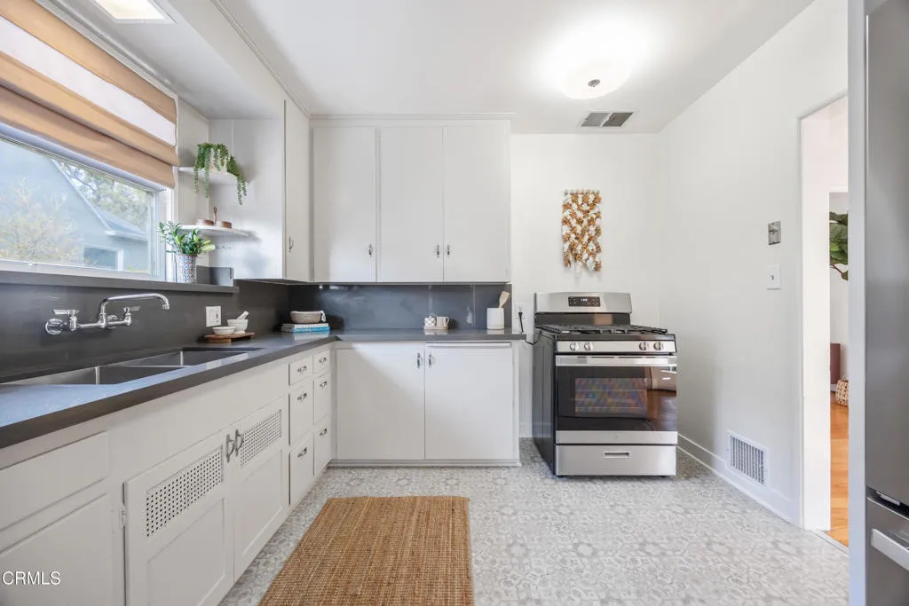 1766 Whitefield Road Pasadena, CA 91104 - Photo 20 of 52 a kitchen with stainless steel appliances a stove a sink and white cabinets