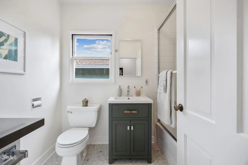 1766 Whitefield Road Pasadena, CA 91104 - Photo 37 of 52 a bathroom with a granite countertop toilet a sink and a mirror