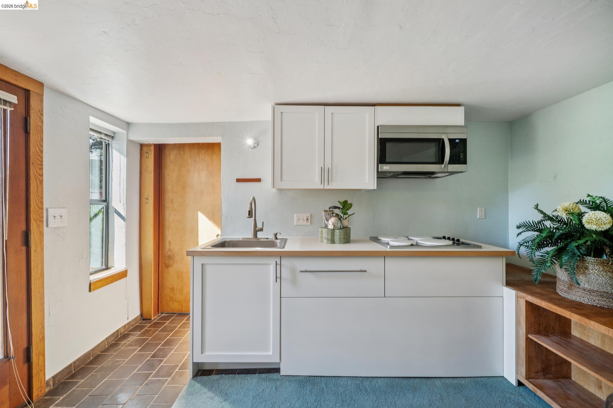 813 San Diego Road Berkeley, CA 94707 - Photo 54 of 60 a kitchen with stainless steel appliances granite countertop white cabinets a microwave a sink and a refrigerator