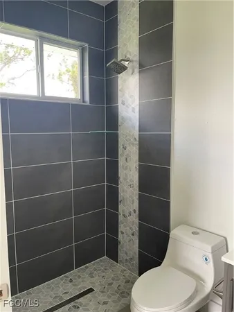 a bathroom with a toilet and a shower