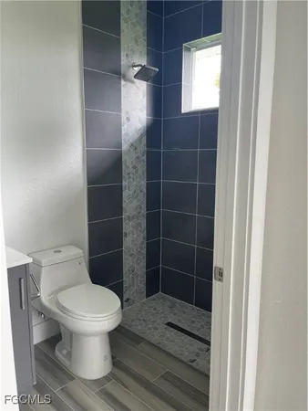 a bathroom with a toilet and a shower