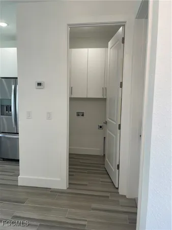 a view of a hallway with wooden floor and staircase