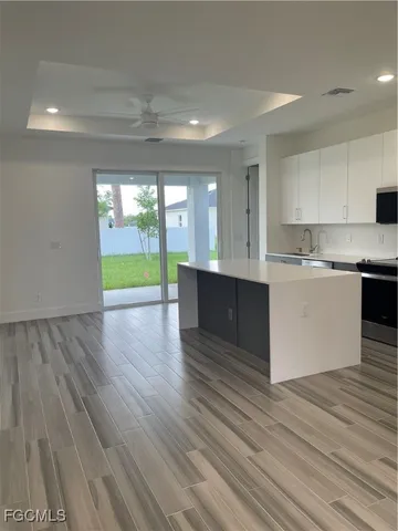 a view of kitchen with cabinets and wooden floor