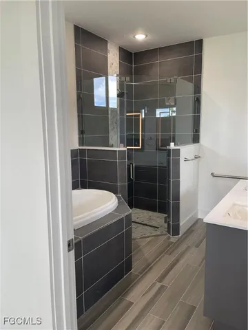 a bathroom with a shower and a sink