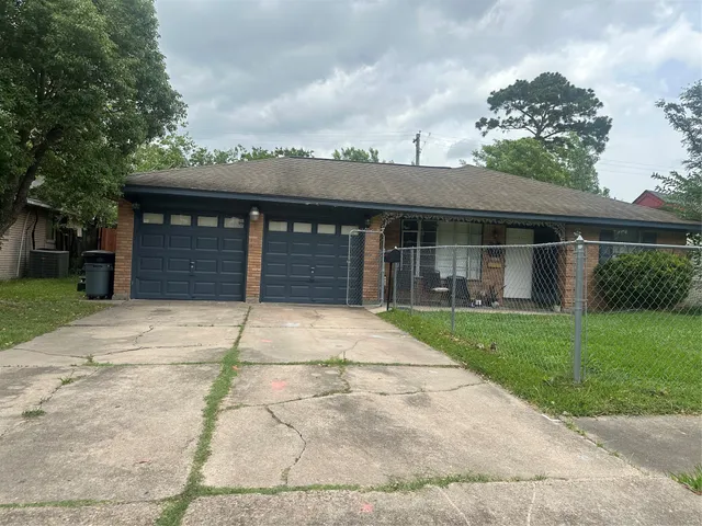 front view of a house with a yard and a garage