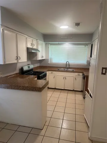 a kitchen with stainless steel appliances granite countertop a sink and a stove