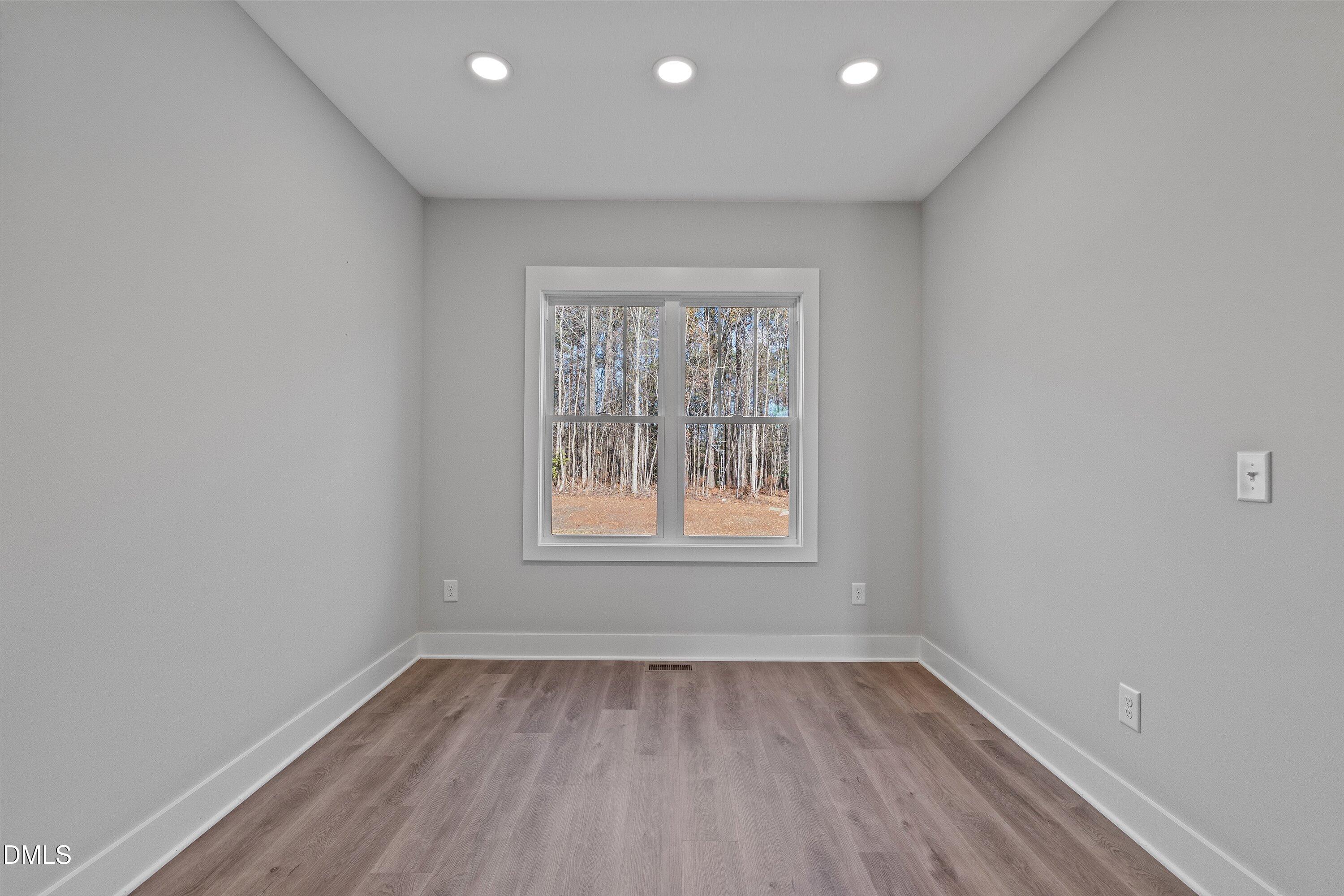 9400 Turkey Way Middlesex, NC 27557 - Photo 10 of 31 an empty room with wooden floor and windows